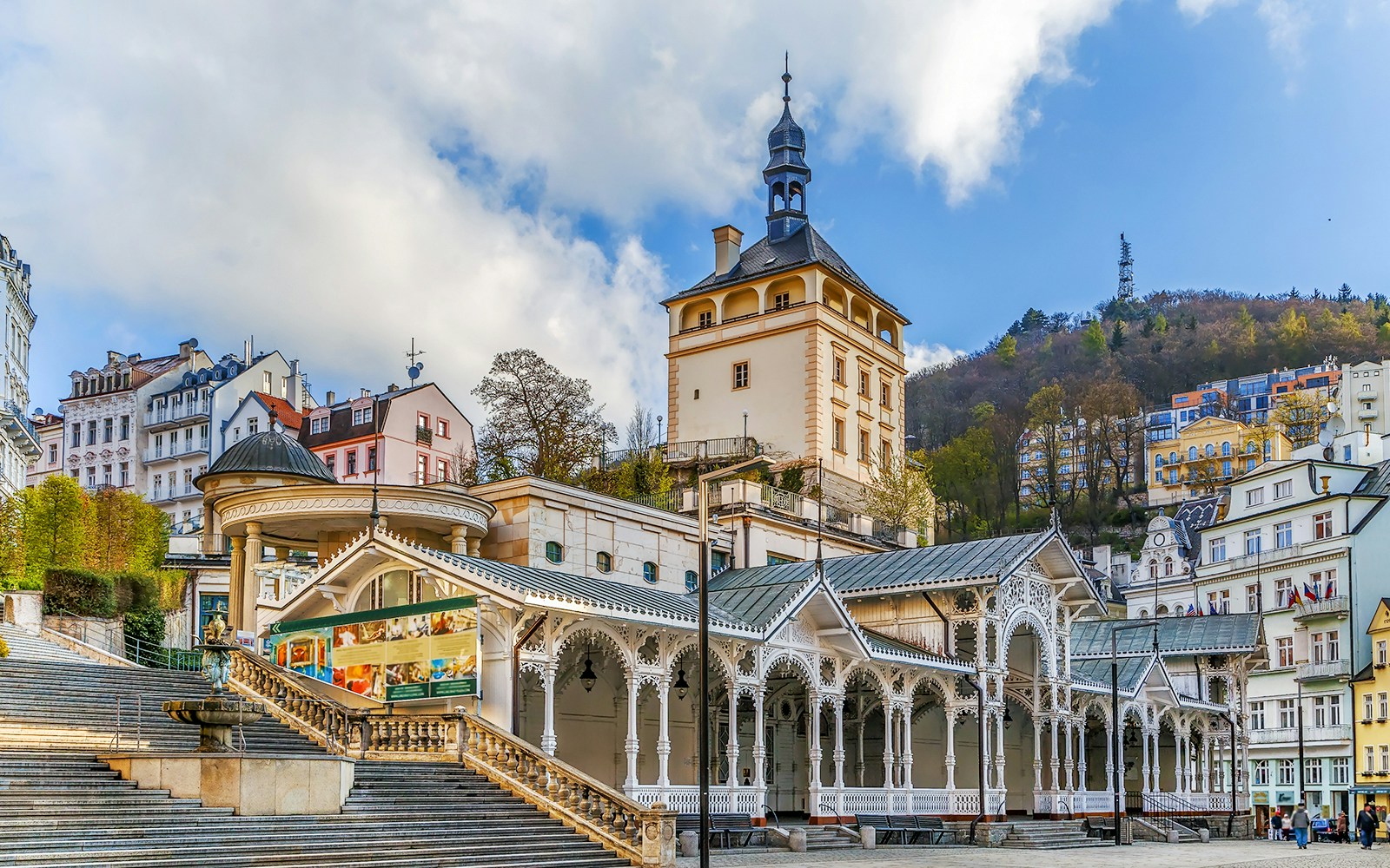 Karlovy Vary colonnade and historic buildings with Watchtower Diana in the background.
