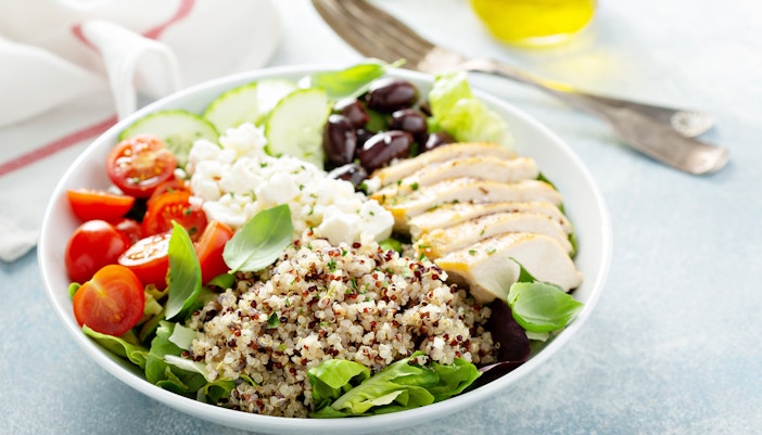 salad with chicken, tomatoes, cucumbers, olives, and feta at Space Bowl Bistro.