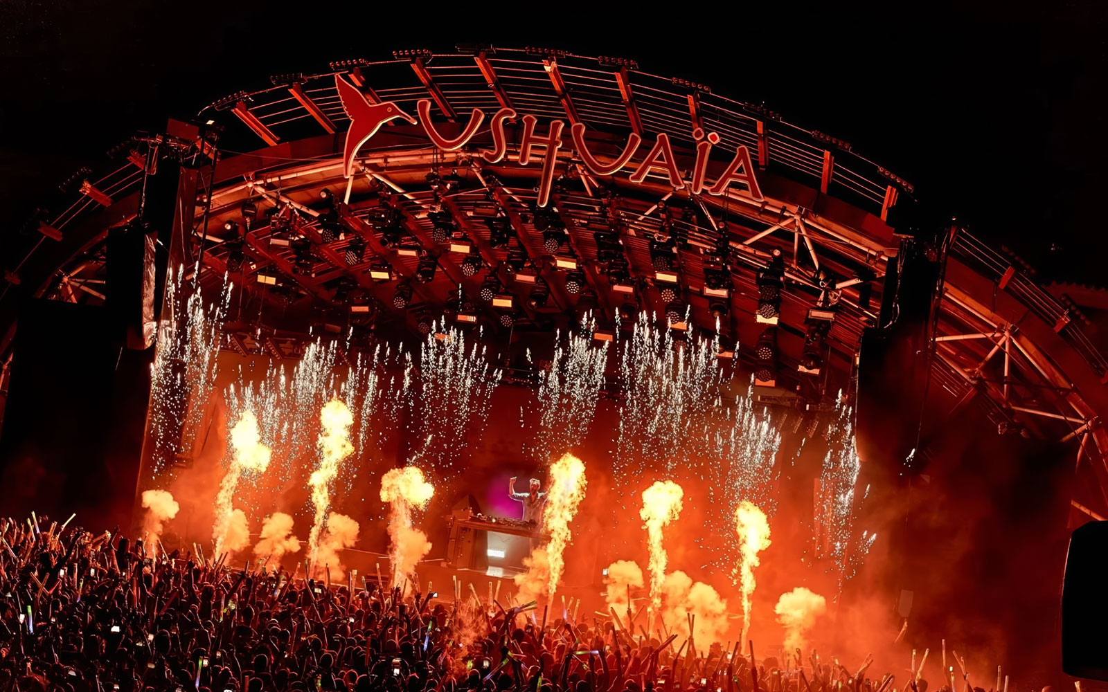 Performance by DJ at Ushuaia Ibiza with fireworks and crowd.