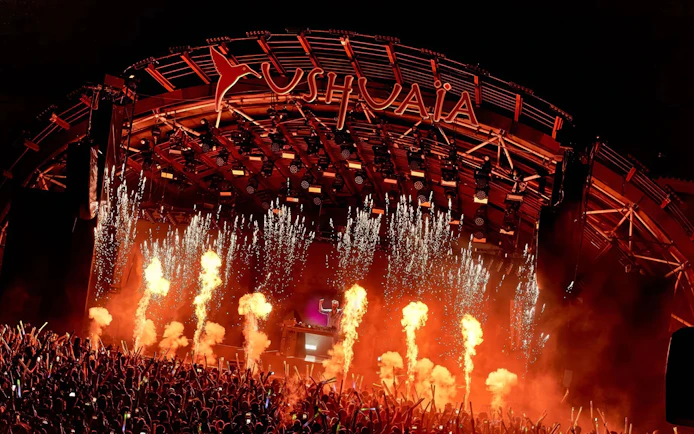 Performance by DJ at Ushuaia Ibiza with fireworks and crowd.