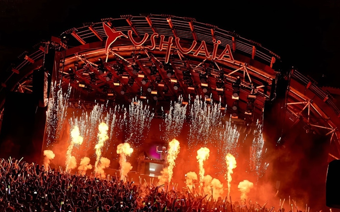 Performance by DJ at Ushuaia Ibiza with fireworks and crowd.
