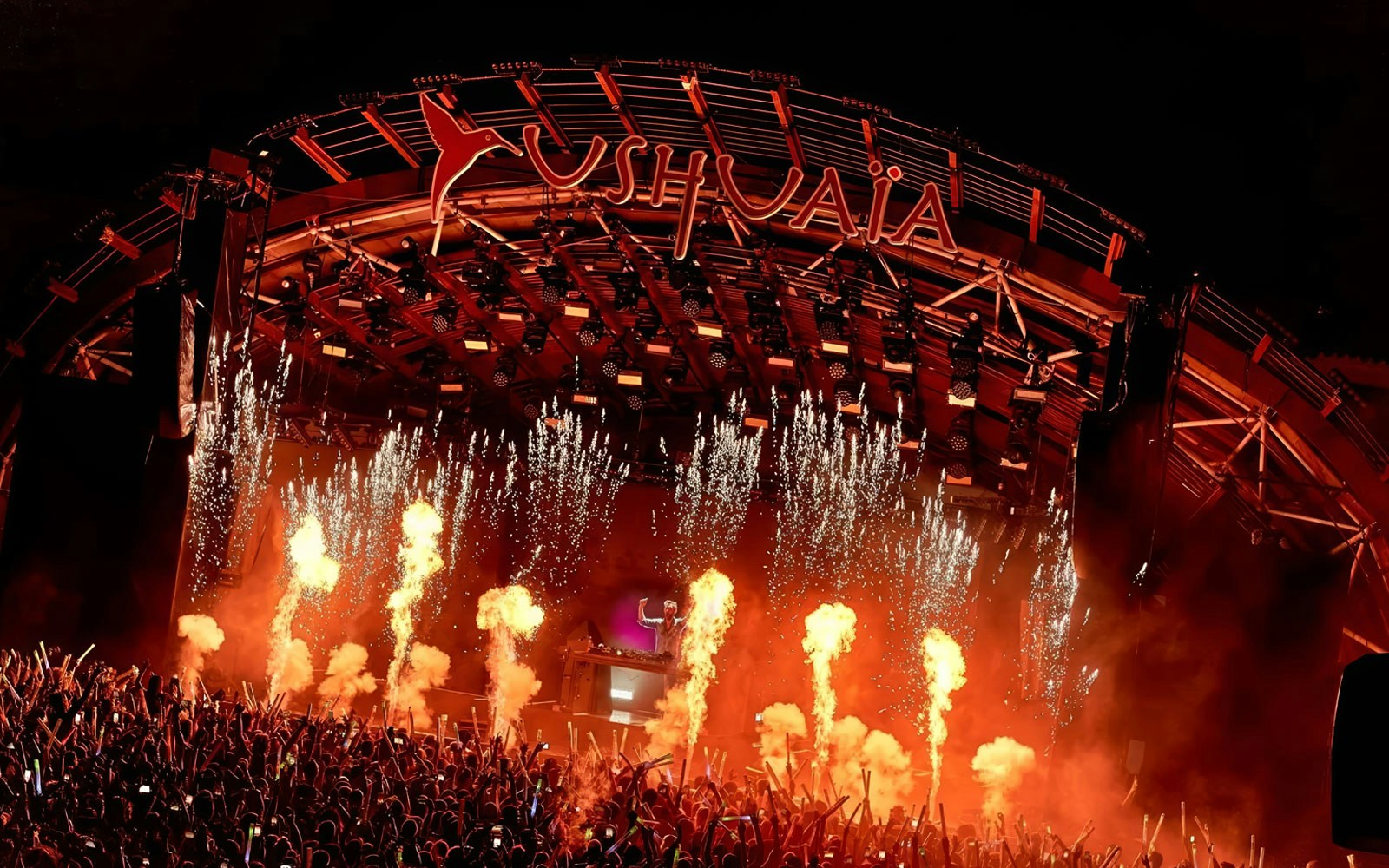 Performance by DJ at Ushuaia Ibiza with fireworks and crowd.