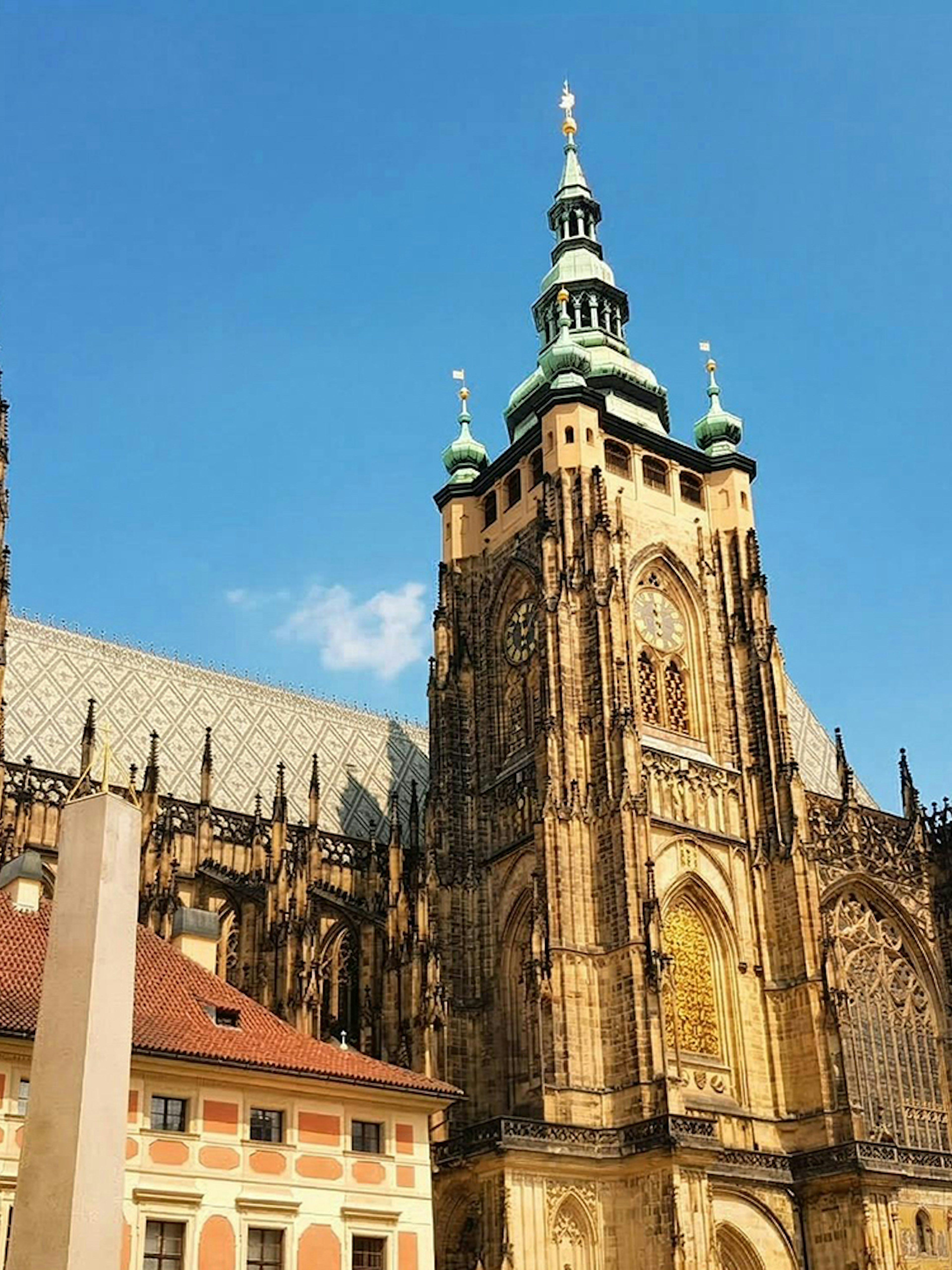 Prague Castle with Gothic architecture under a clear blue sky.