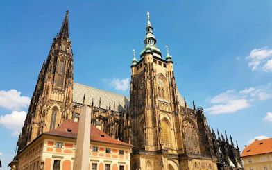 Prague Castle with Gothic architecture under a clear blue sky.