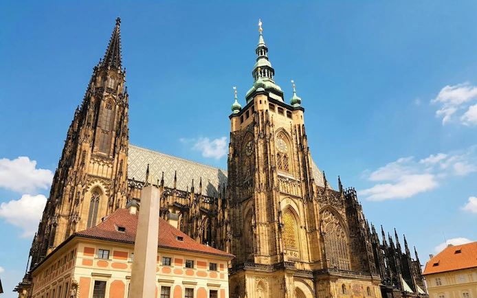 Prague Castle with Gothic architecture under a clear blue sky.