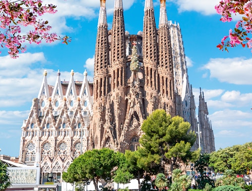 Sagrada Familia basilica in Barcelona with reflection in pond.