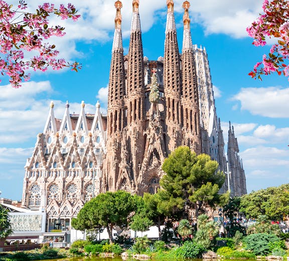 Sagrada Familia basilica in Barcelona with reflection in pond.