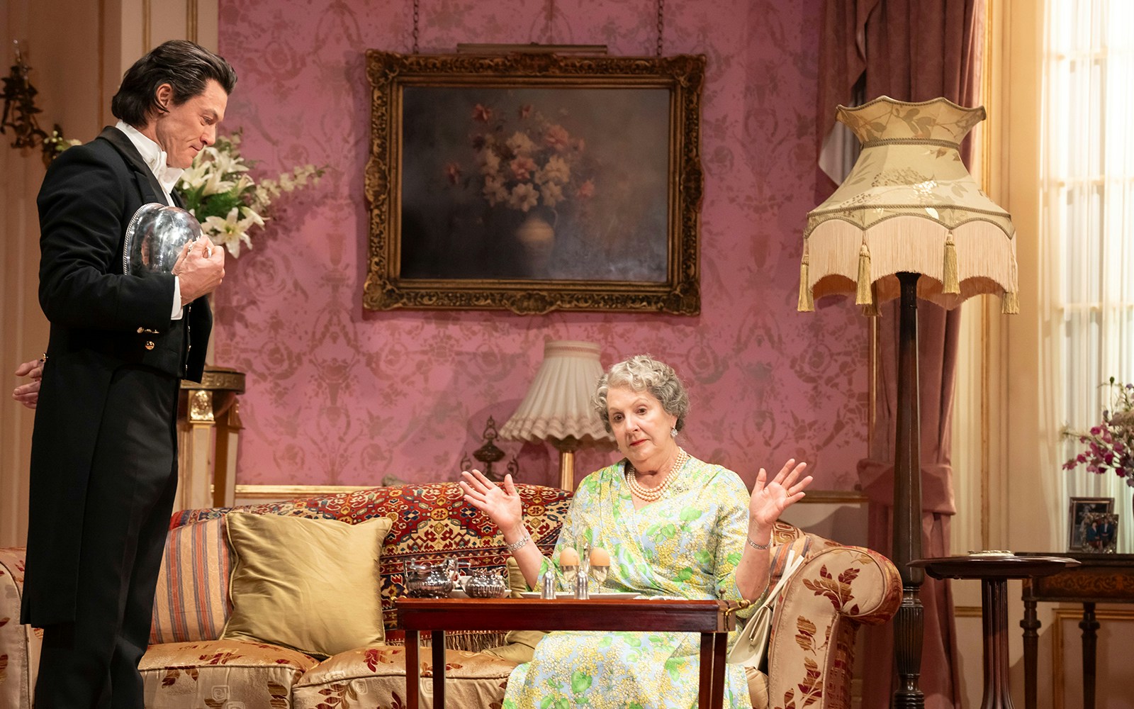 Butler serving tea to a woman in an elegant living room, related to Backstairs Billy.