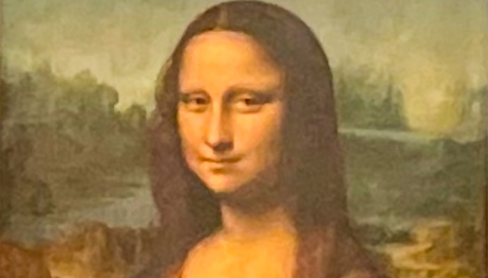 Mona Lisa painting displayed at the Louvre Museum in Paris, France.