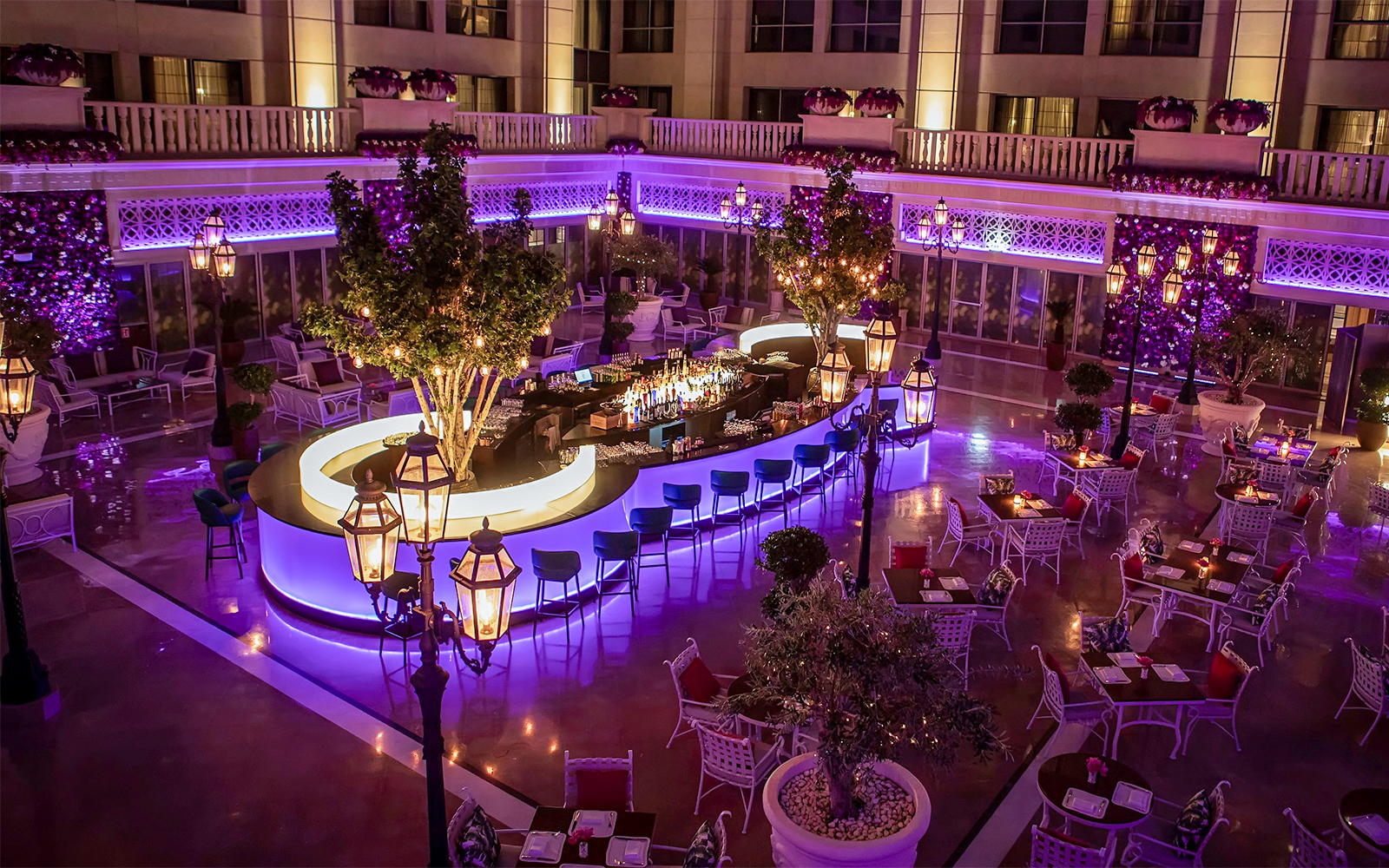 Outdoor dining area at Le Patio Restaurant with illuminated bar and seating, Dubai.
