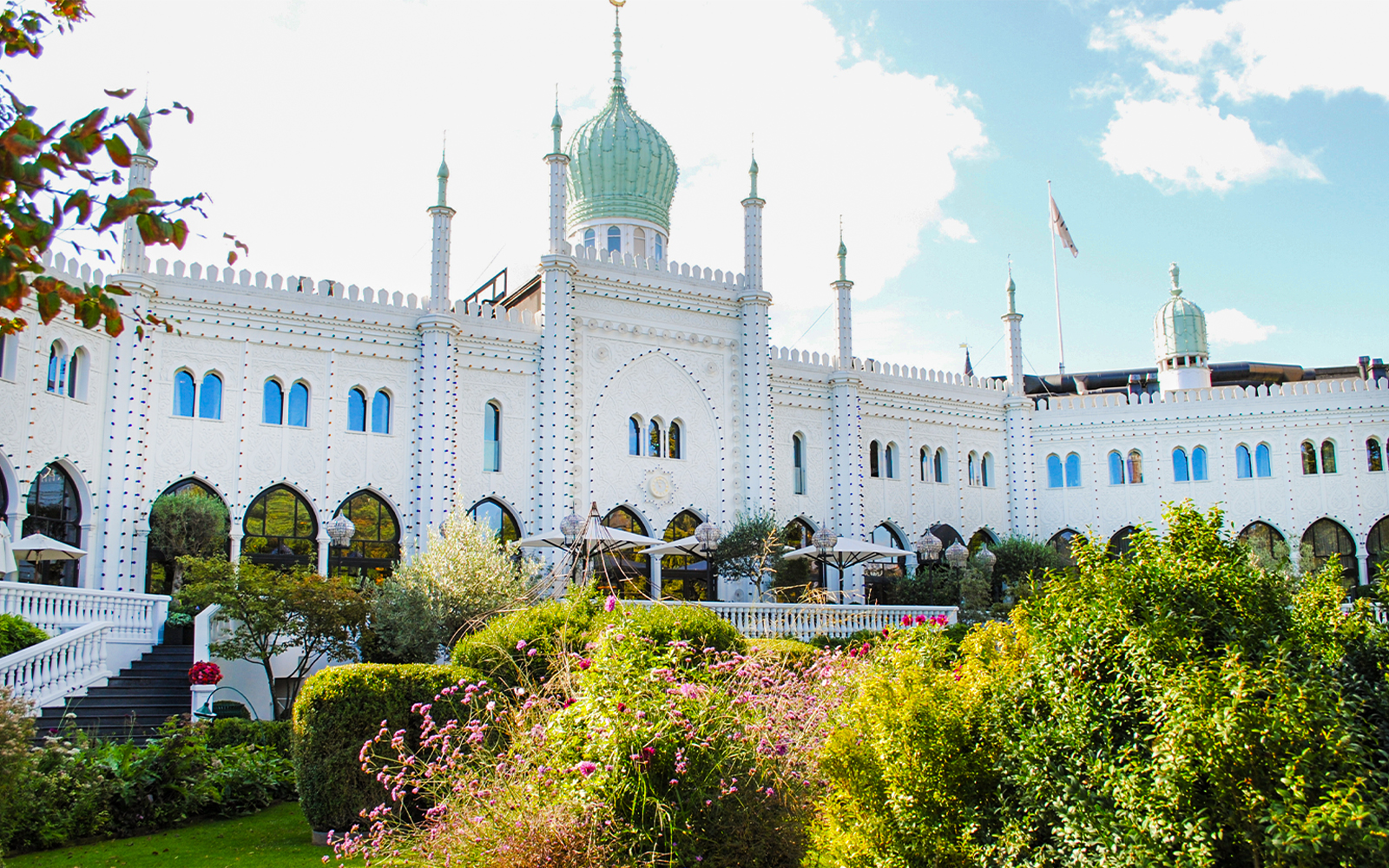 Tivoli Gardens' Moorish Palace in Copenhagen, Denmark, surrounded by lush gardens.