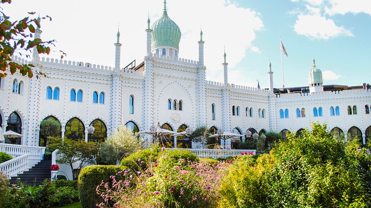 Tivoli Gardens' Moorish Palace in Copenhagen, Denmark, surrounded by lush gardens.