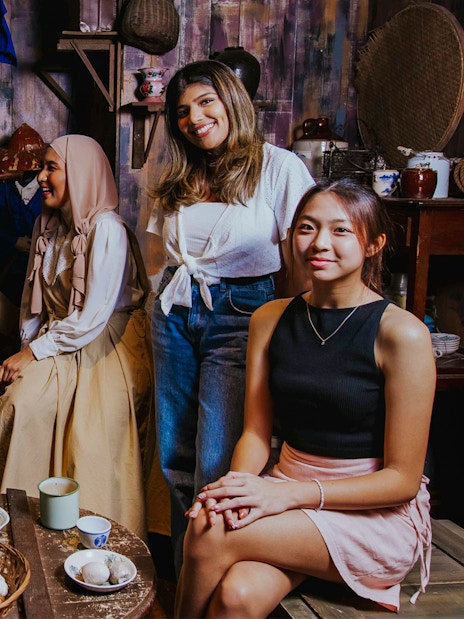 Visitors interacting in the Coolie Quarters exhibit at Madame Tussauds Singapore.