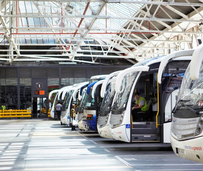 Coaches lined up at a station, ready for one-way trips from Heathrow Airport to London Victoria.