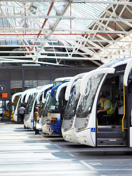 Coaches lined up at a station, ready for one-way trips from Heathrow Airport to London Victoria.