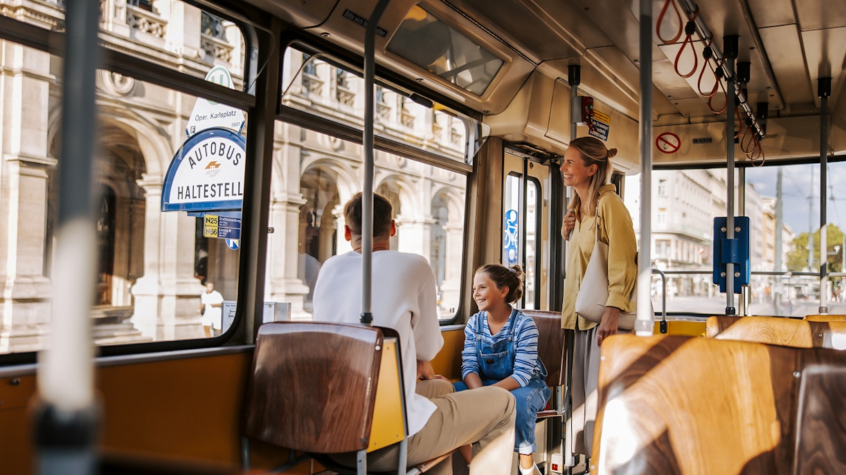 Passengers enjoying a ride on a Vienna tram near Karlsplatz.