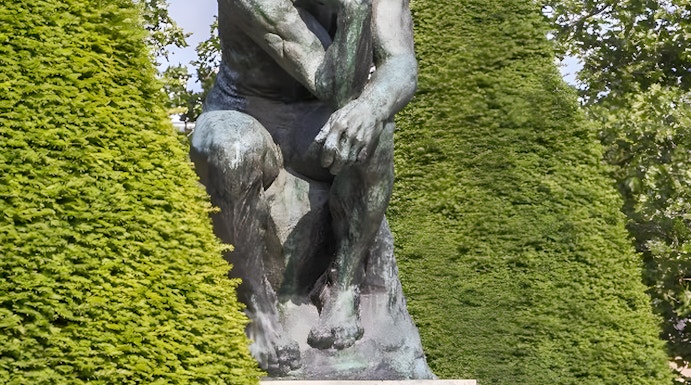 The Thinker sculpture at Rodin Museum surrounded by greenery.