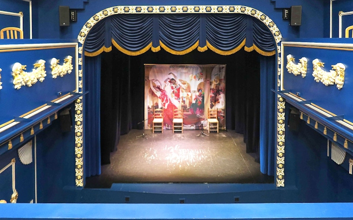 Triana Theater stage set for a flamenco show with decorative blue and gold interior.