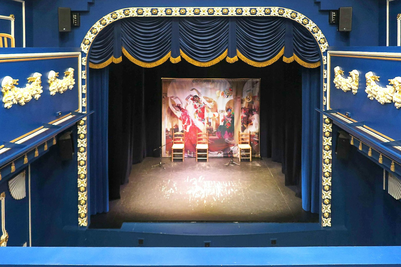 Triana Theater stage set for a flamenco show with decorative blue and gold interior.