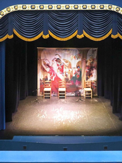 Triana Theater stage set for a flamenco show with decorative blue and gold interior.