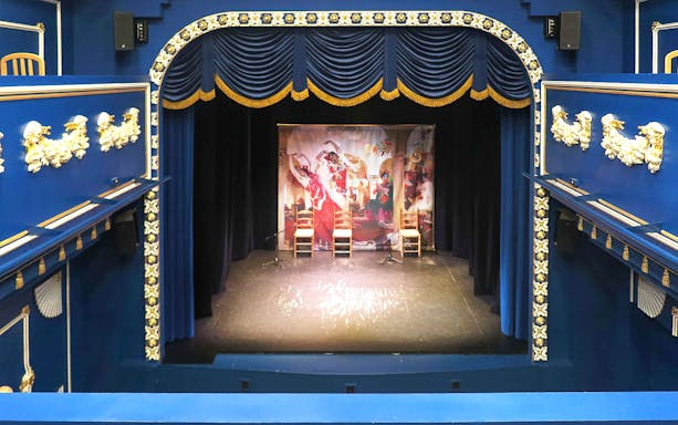 Triana Theater stage set for a flamenco show with decorative blue and gold interior.
