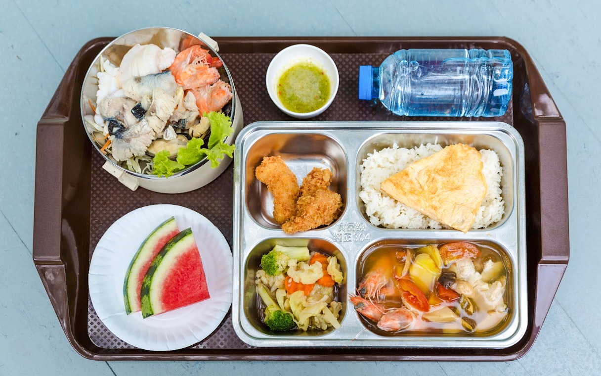 Seafood and fruit breakfast buffet on a beachside tray.