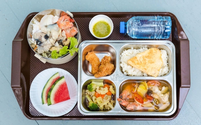 Seafood and fruit breakfast buffet on a beachside tray.