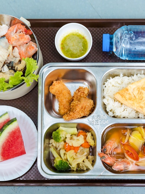 Seafood and fruit breakfast buffet on a beachside tray.