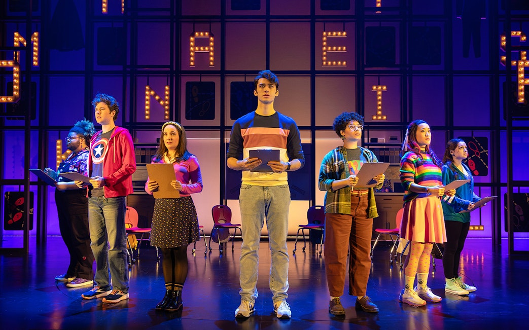 Performers on stage holding clipboards during "How to Dance in Ohio" show.