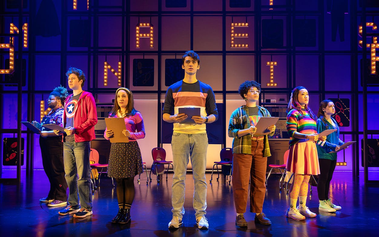 Performers on stage holding clipboards during "How to Dance in Ohio" show.