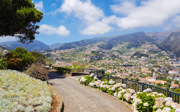 Pathway overlooking Nun's Valley with mountain and village views on Areiro Peak tour.