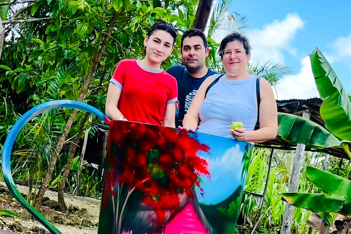 Group posing with colorful artwork at Punta Cana craft market.
