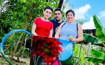 Group posing with colorful artwork at Punta Cana craft market.