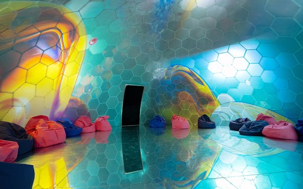 Colorful spheres and bean bags at Immersive Bubble Planet exhibit in Singapore.