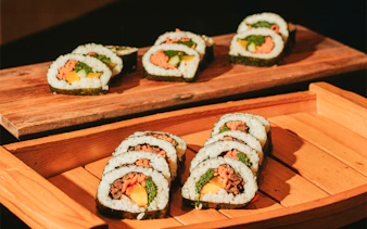 Sushi rolls served on wooden platters at Na Lei Aloha Luau, Waikīkī.