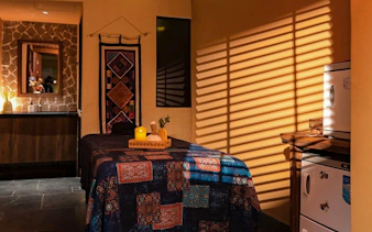 Herbal Spa treatment room with massage table and candles in Da Nang.