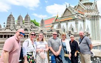Group of tourists at Wat Phra Kaew, Bangkok, during Grand Palace tour.