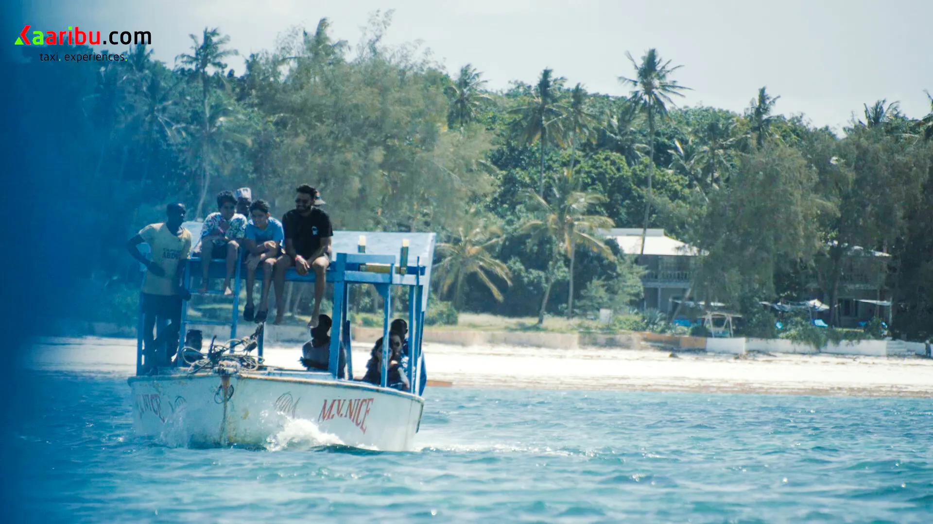 Glass-bottom boat with tourists near Robinson Island, Diani Beach, surrounded by palm trees.
