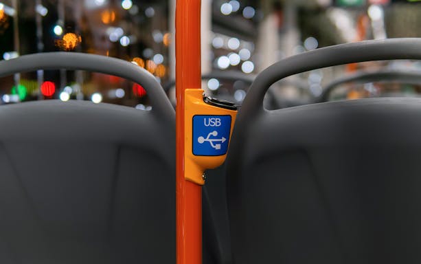 USB charging port on a bus seat for Matera to Naples Metropark route.