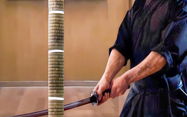 Samurai performing trial cutting with a katana in Tokyo theater.