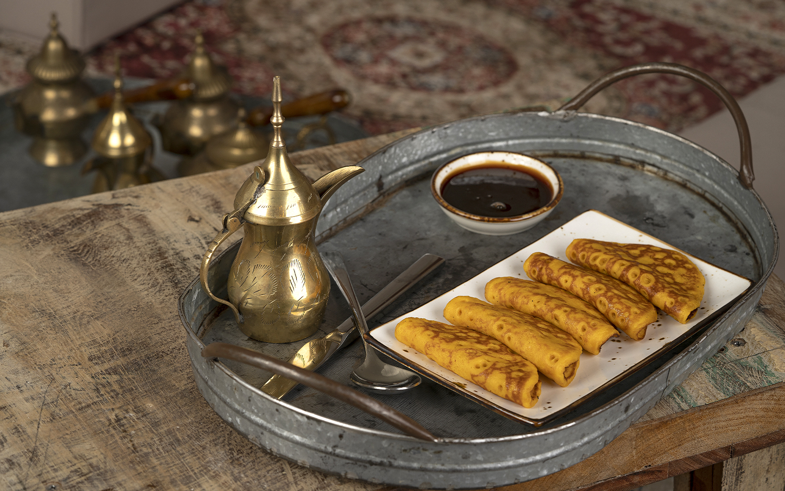 Emirati coffee pot and pastries on a tray at Gahwat Nasser.