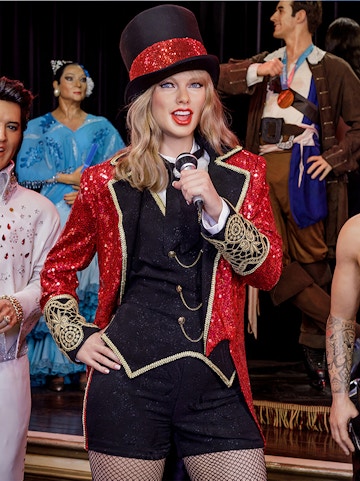 Performer wax figure in red and black costume at Wax Museum Madrid.