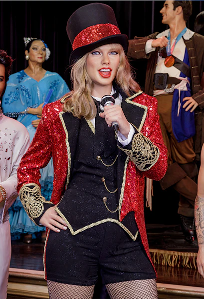Performer wax figure in red and black costume at Wax Museum Madrid.