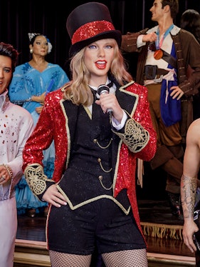 Performer wax figure in red and black costume at Wax Museum Madrid.