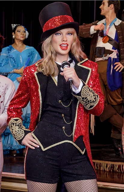 Performer wax figure in red and black costume at Wax Museum Madrid.