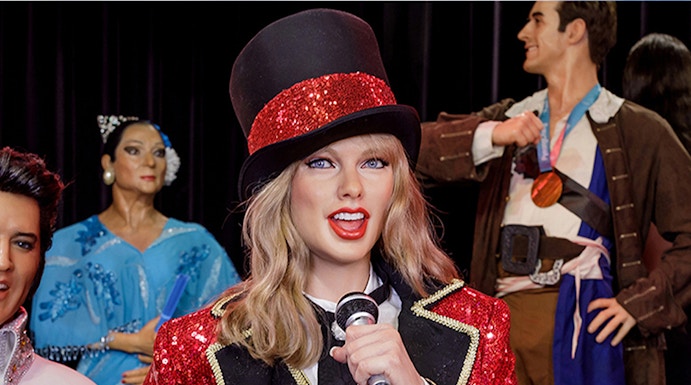 Performer wax figure in red and black costume at Wax Museum Madrid.