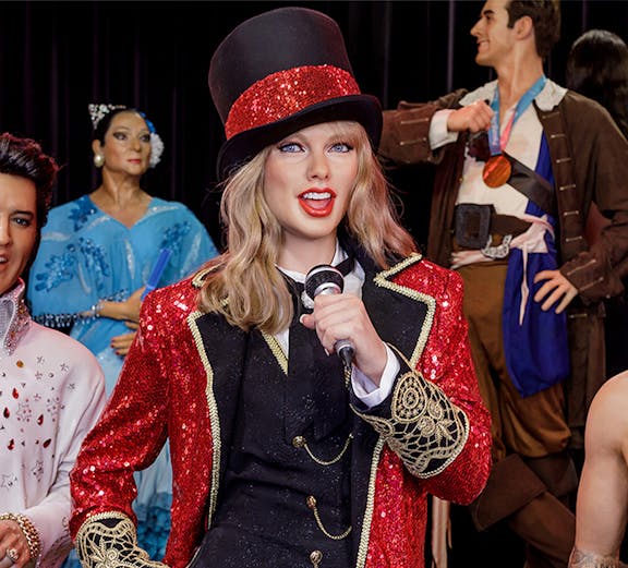 Performer wax figure in red and black costume at Wax Museum Madrid.