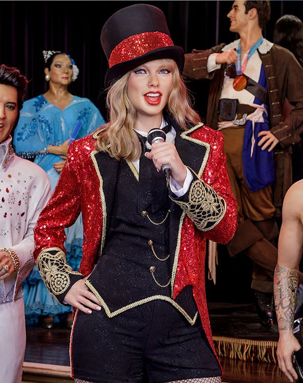 Performer wax figure in red and black costume at Wax Museum Madrid.