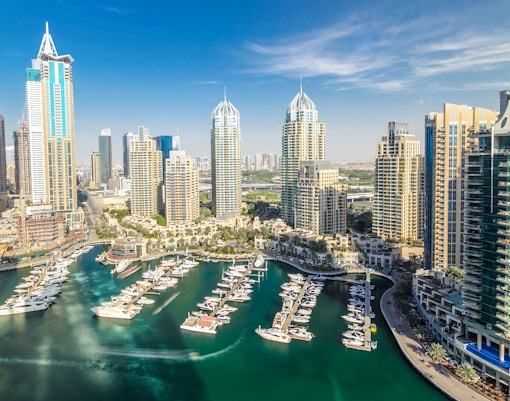 Aerial view of Dubai Marina with skyscrapers and yachts in Dubai.