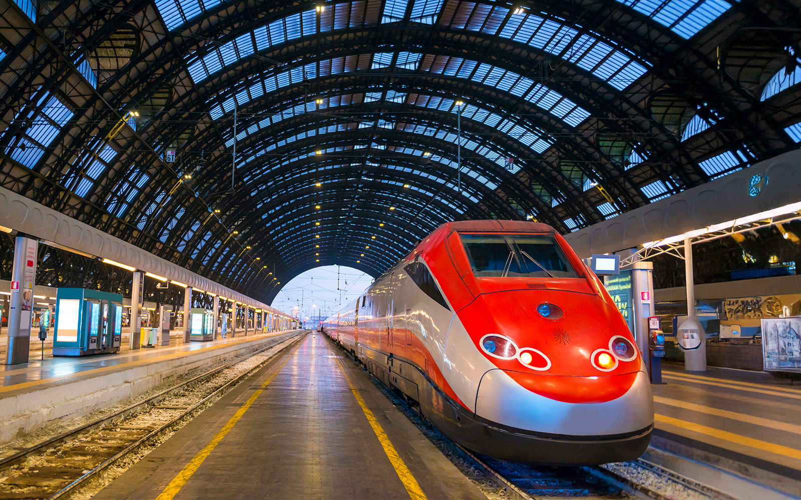 Trenitalia train at dusk in Milan's railroad station.